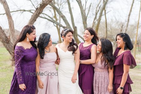 Photo of Bride with matching bridesmaids in purple