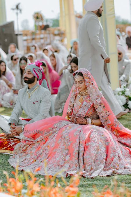 Photo of Bridal portrait in coral lehenga on Anand Karaj