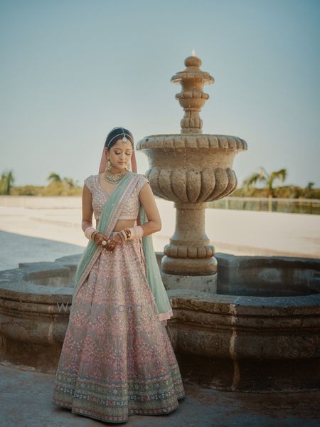 Photo of pink and blue pastel bridal lehenga with contrasting dupatta