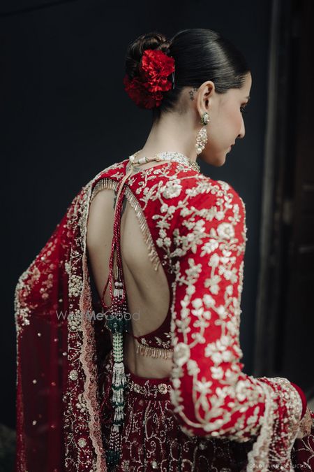 Photo of Lovely all red cutout style backless blouse with full sleeves and gold embroidery for the wedding lehenga