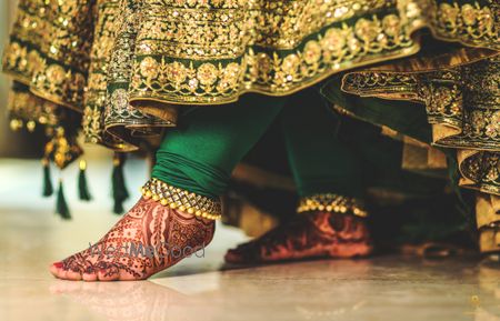 Photo of bridal payal or pajeb with green anarkali