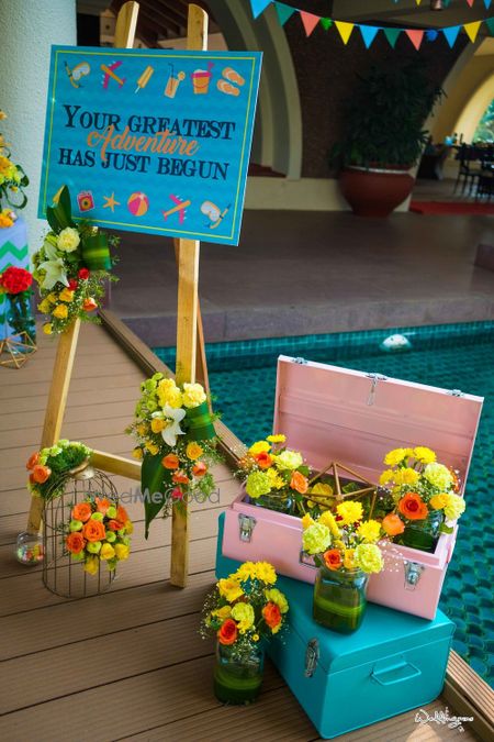 Photo of Mehendi decor idea with painted trunks and flowers in mason jars