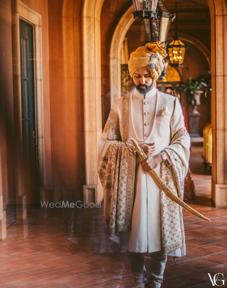 Photo of Royal groom look with him holding a sword