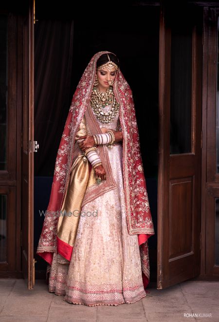 Photo of Peach, pink and gold bridal lehenga