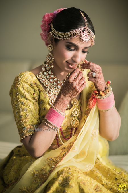 Photo of A bridal portrait captured as the bride shyly gets ready