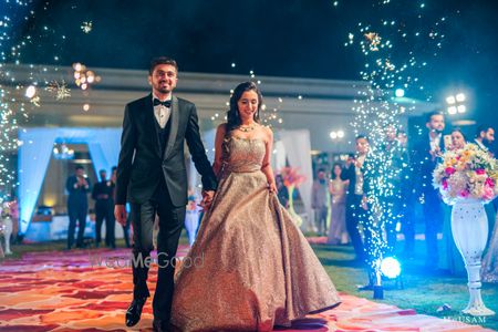 Photo of couple entry on reception with fireworks