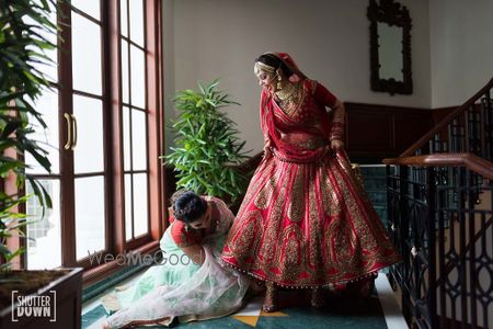 Photo of Cute bride and bridesmaid photo helping out