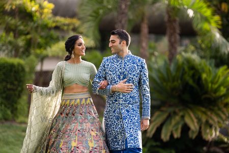 Photo of couple portrait wearing sangeet lehenga and sherwani