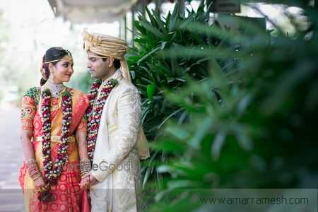 Photo of South Indian Couple Holding Hands Wearing Var Mala