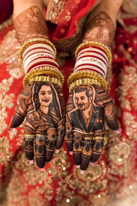 Photo of Bridal mehendi with portrait with customised Chura