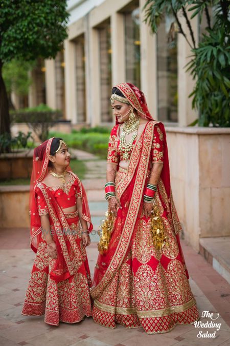 Photo of Bride with mini bride photo at wedding