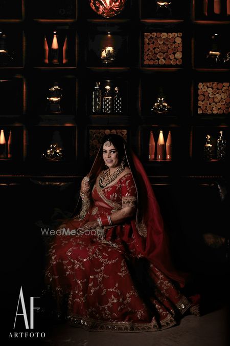 Photo of Red sabyasachi zardozi work lehenga on bride