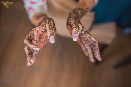 Photo of Unique mehendi design on bridal nails