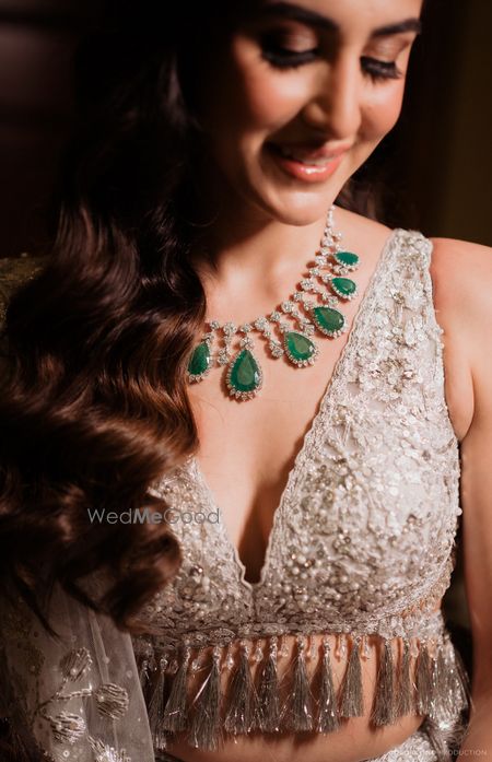 Photo of Statement diamond and emerald bridal necklace for the sangeet night with a plunge neckline blouse