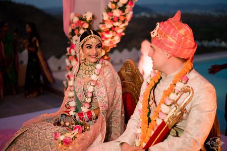 Photo of A romantic couple caught in a candid moment on their wedding.