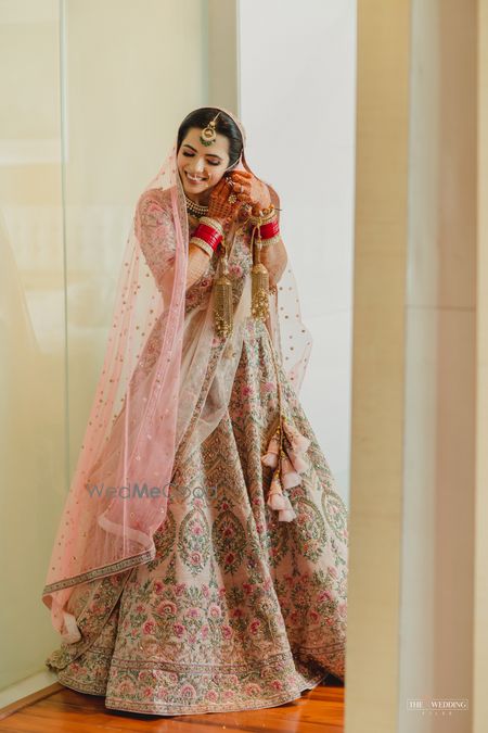 Photo of Bride fixing her earrings.