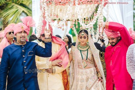 Photo of Bride entering with brothers carrying phoolon ka chadar