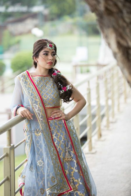 Photo of Ice blue and pink mehendi lehenga with floral braid