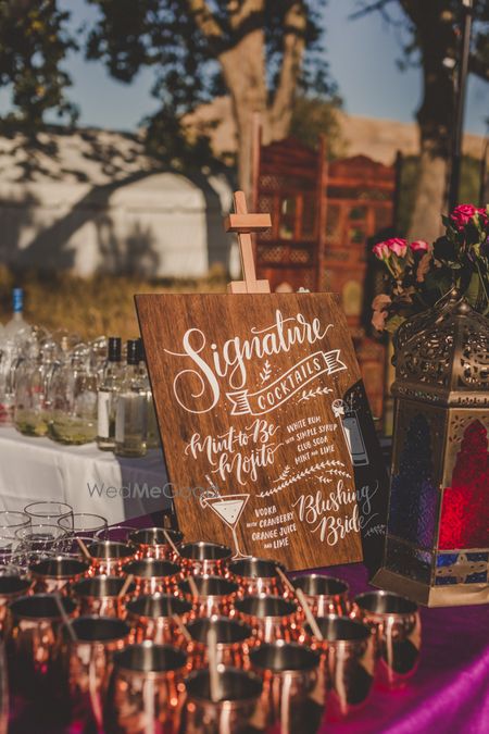 Photo of Rustic wooden bar sign with cocktails