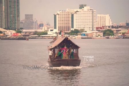 Photo of Bride entry on a shikara from across the lake