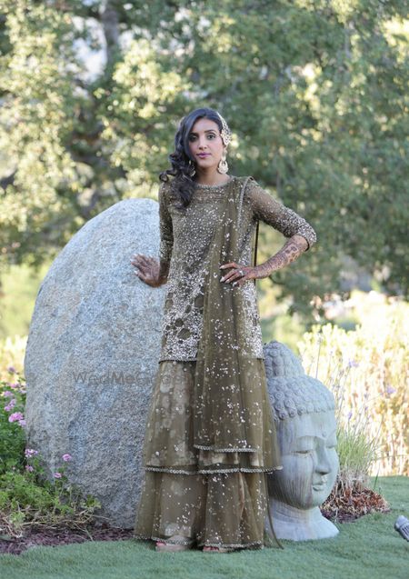 Photo of bridal mehendi look in green sequin sharara wearing passa