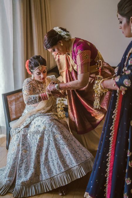 Photo of Bride getting ready shot idea with mother helping