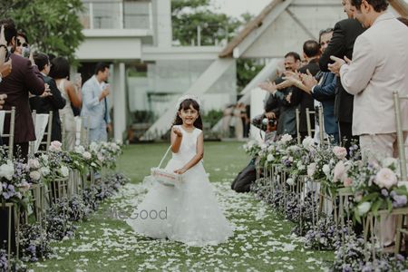 Photo of Flower girl walking down the aisle