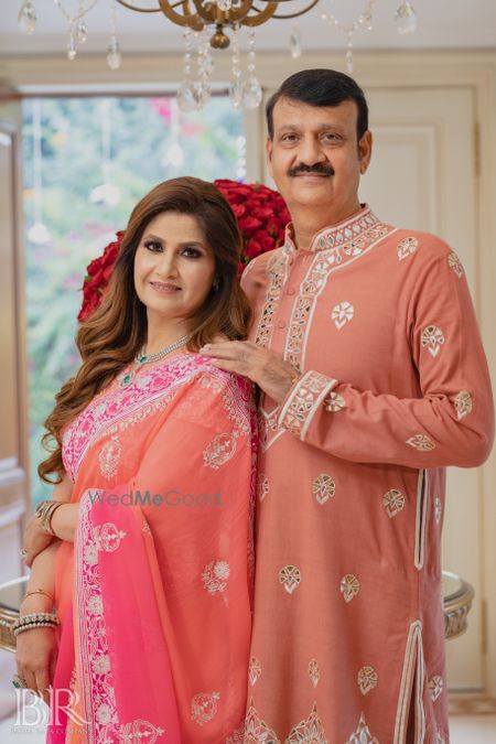 Photo of mother and father of the bride in matching outfits