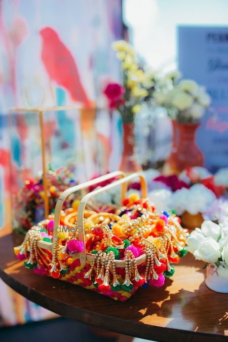 Photo of Mehendi favour ideas with pompom jewellery on display