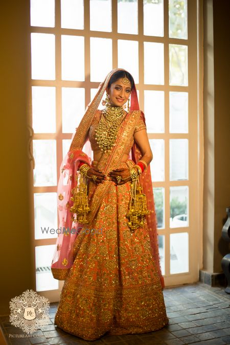 Photo of Pink and gold bridal lehenga