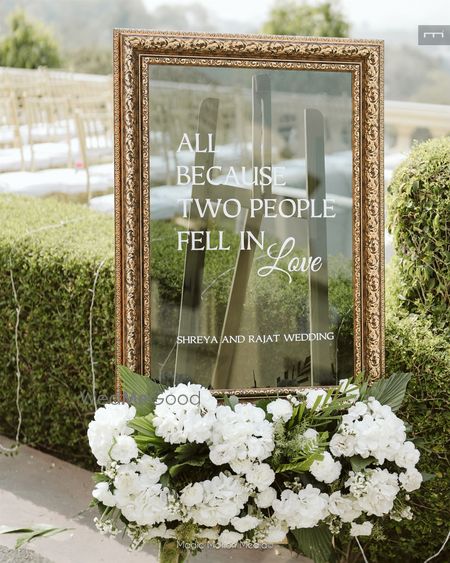 Photo of Lovely signage in mirror style with white and green florals for the entrance