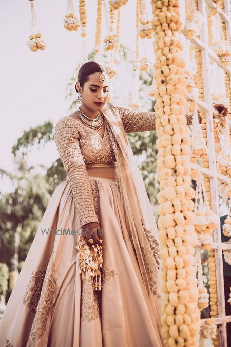 Photo of Beige bridal lehenga with full sleeves blouse