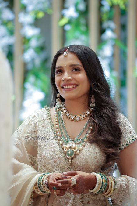 Photo of Ivory bride with stunning and unique bridal jewellery and pearl earrings