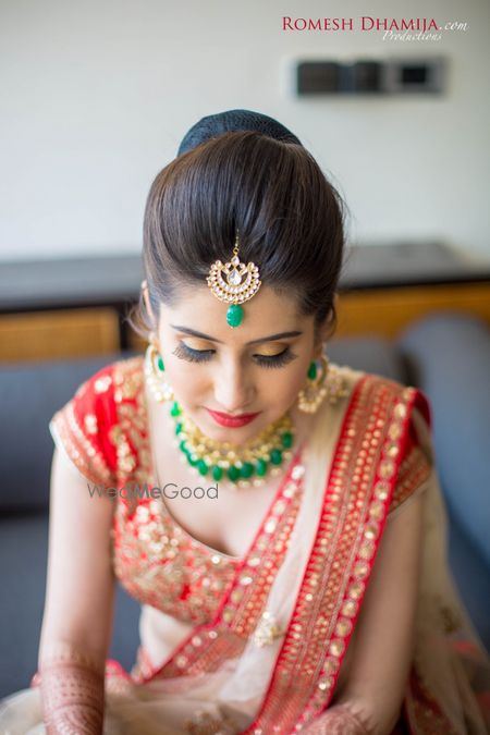 Photo of Contrast jewellery in emerald green with red lehenga