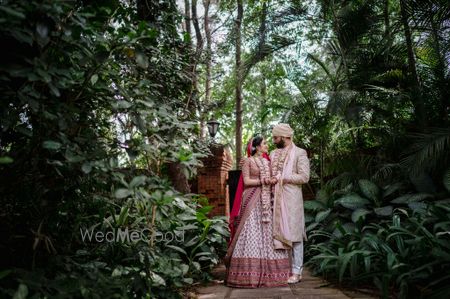 Photo of Bride and groom dressed in colour-coordinated outfits.