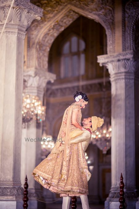 Photo of Romantic couple shot with groom picking bride