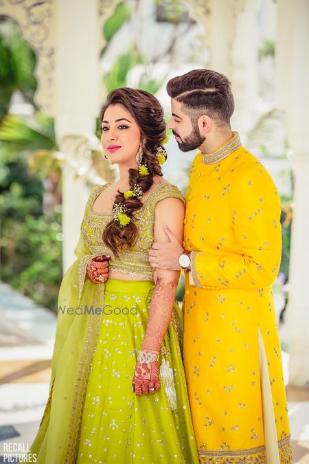 Photo of Lime green lehenga with floral braided hairstyle