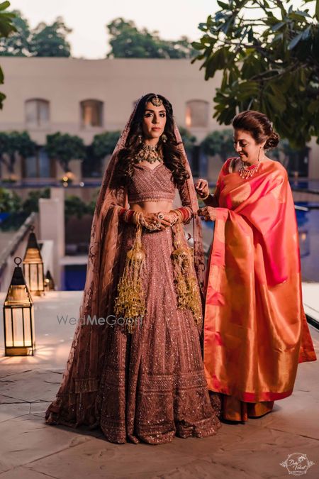 Photo of Bride with her mom getting ready shot