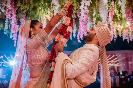 Photo of jaimala exhange shot on pretty floral stage