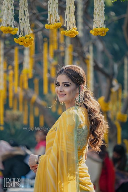 Photo of sister of the bride hairdo with ponytail on mehendi