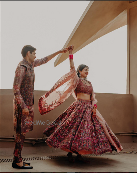 Photo of groom twirling the bride on mehendi