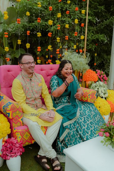 Photo of cute couple portrait against colourful mehendi backdrop