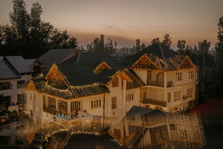 Photo of wedding house covered in golden lighting