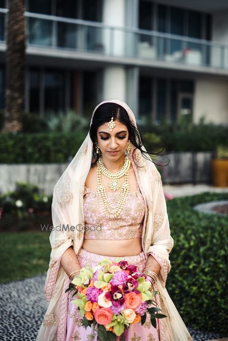 Photo of Pastel bride holding bouquet