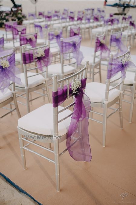 Photo of Purple and lavender ribbon decor with baby breath for chair backs