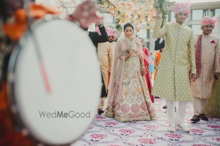 Photo of A beautiful bridal entry under a gorgeous phoolon ki chaadar