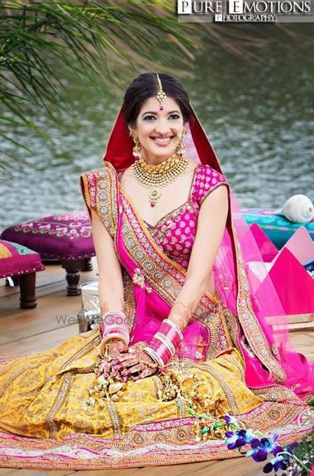 Photo of yellow and pink bridal lehenga