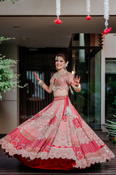 Photo of A happy bridal portrait of the bride caught twirling