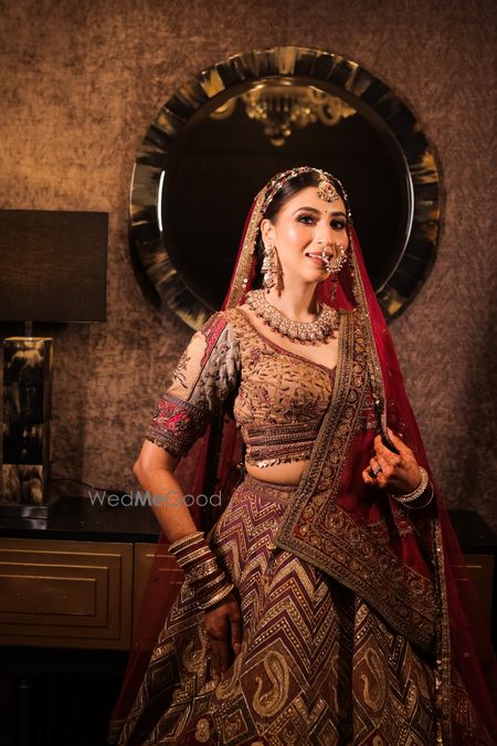 Photo of royal bridal look in a heavy maroon lehenga