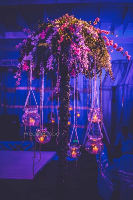 Photo of large tree style table centepieces with hanging candles on cocktail night